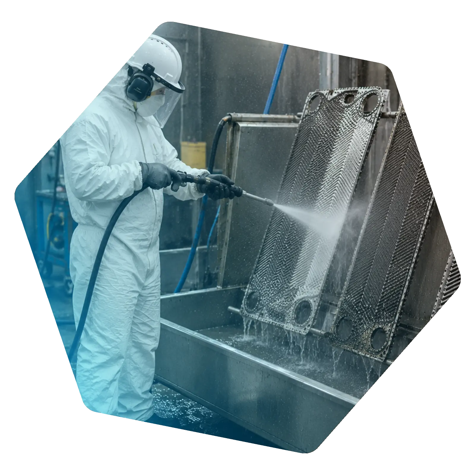 Heat exchanger component being cleaned with a high-pressure water jet in an industrial wash area