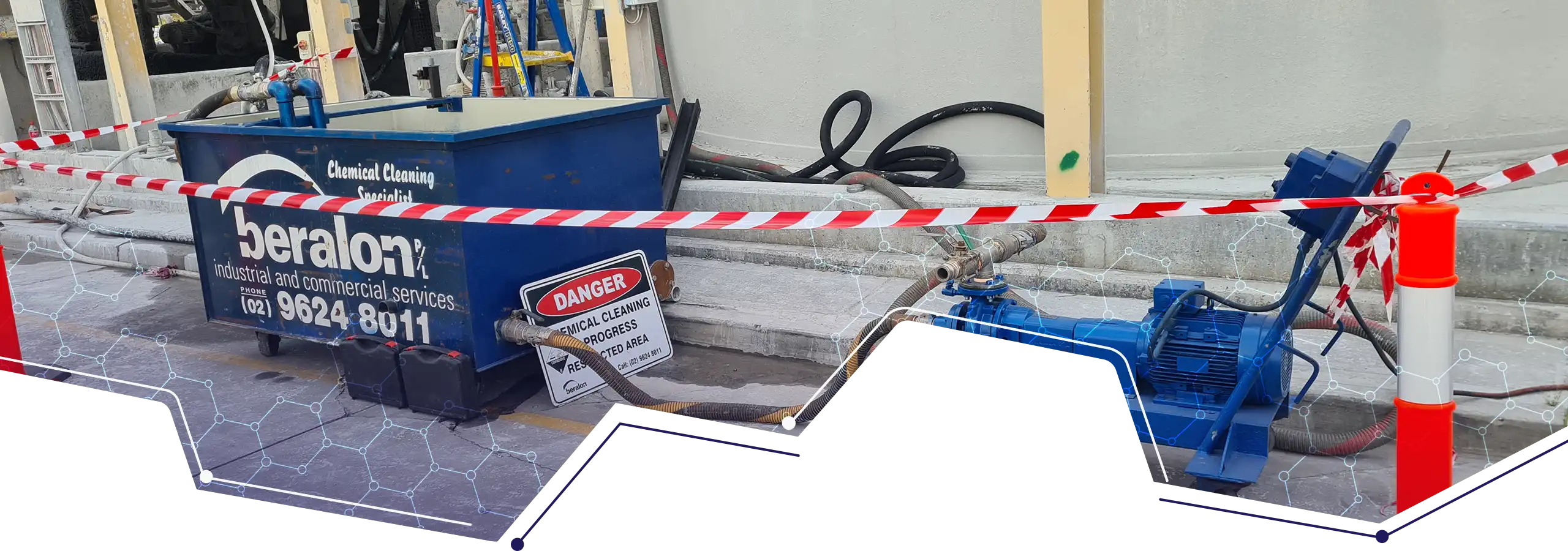 Beralon chemical cleaning tanks and pump connected by hoses in a cordoned industrial work area
